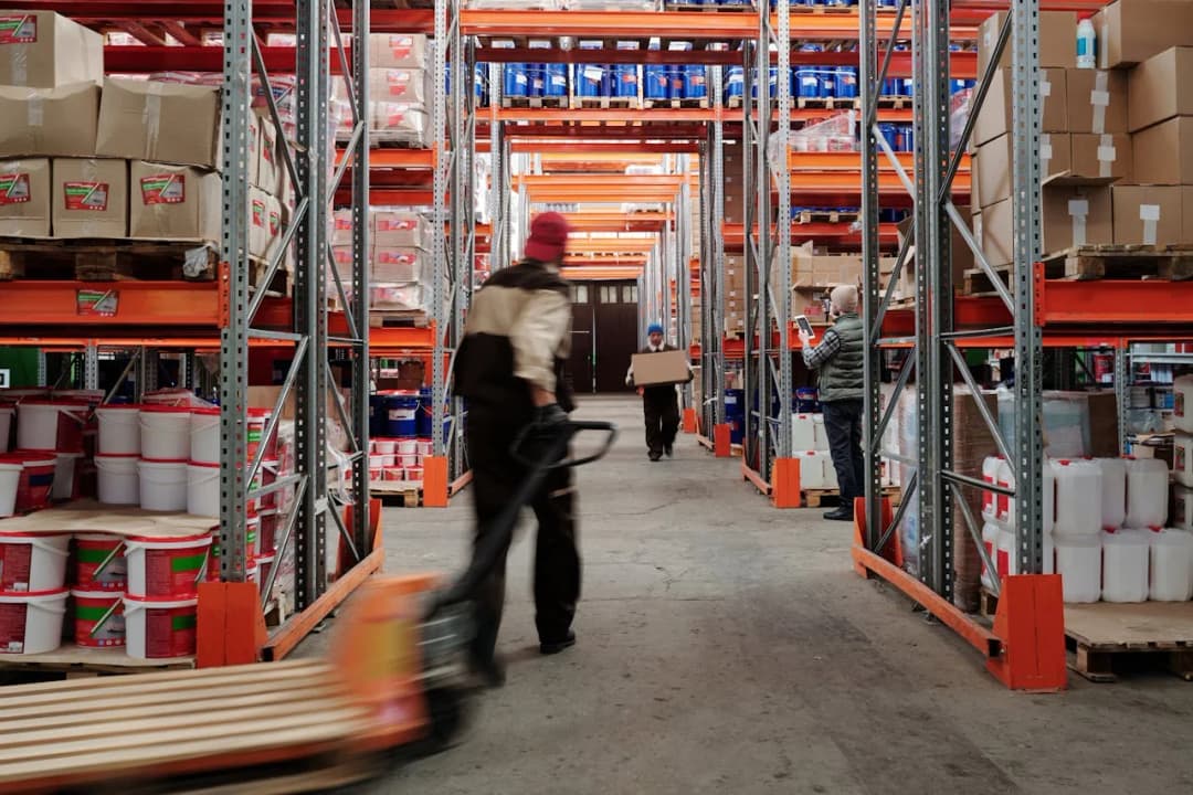 Busy warehouse with workers and pallets